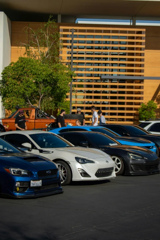 several colorful cars parked in front of a building