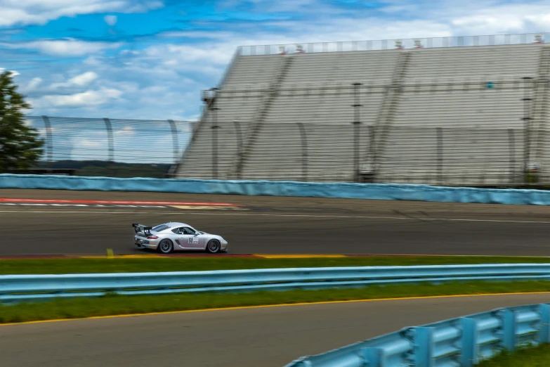 two cars driving around the track while a person takes pictures