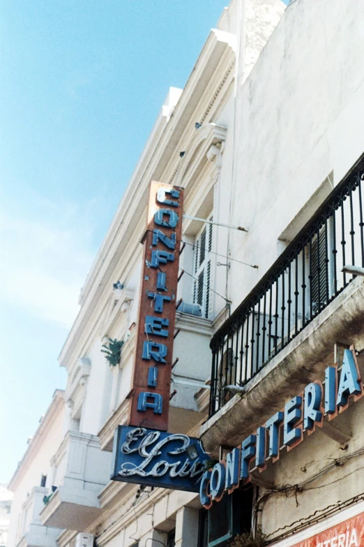 the outside of a restaurant, where the sign is displayed