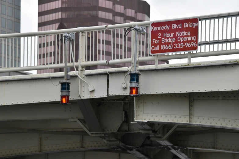 two red lights are hanging on the bridge