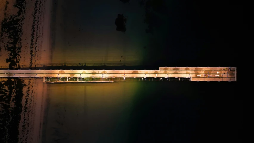 an aerial view of boats on the water at night