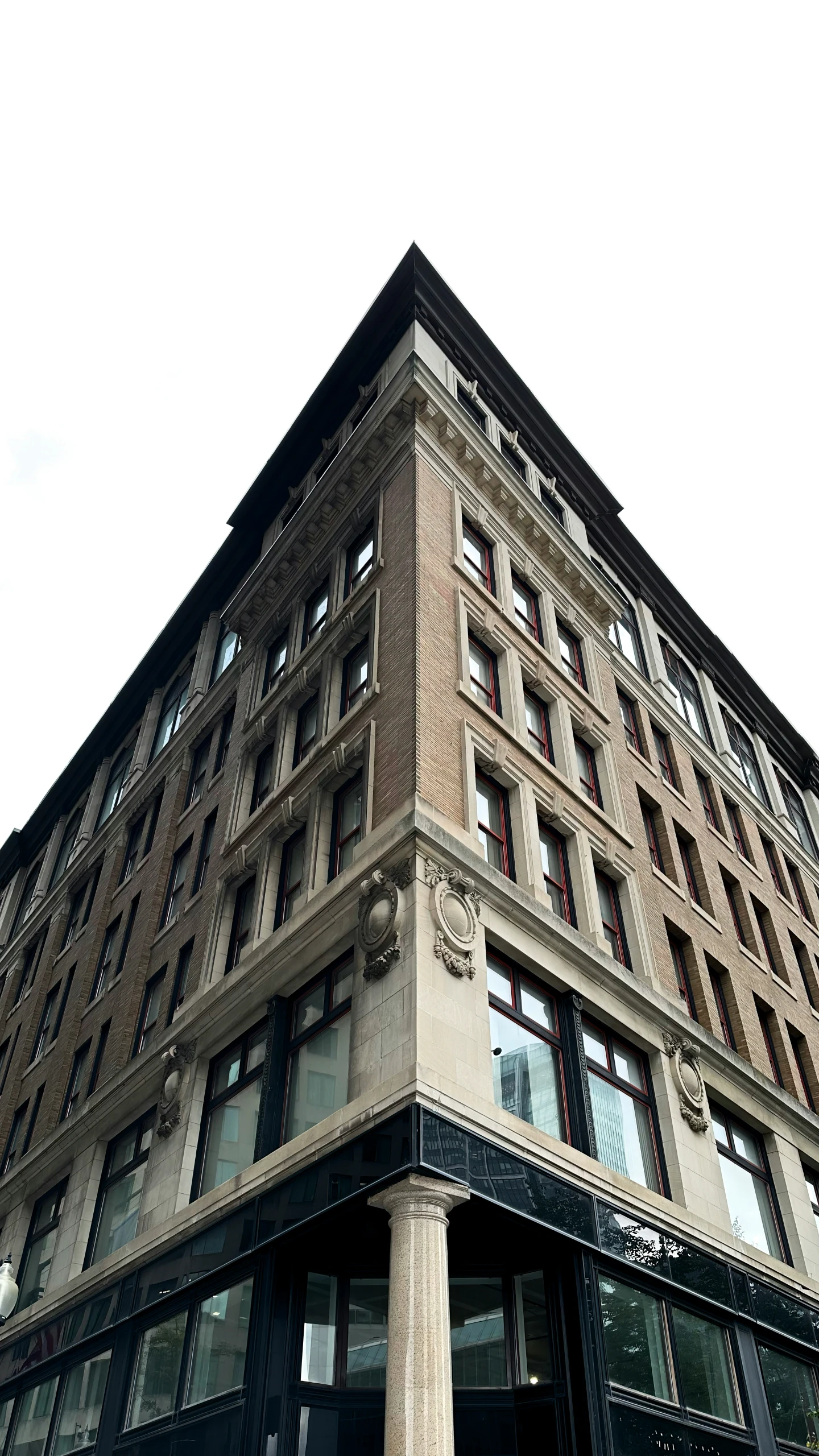 an old brick building with lots of windows in a city