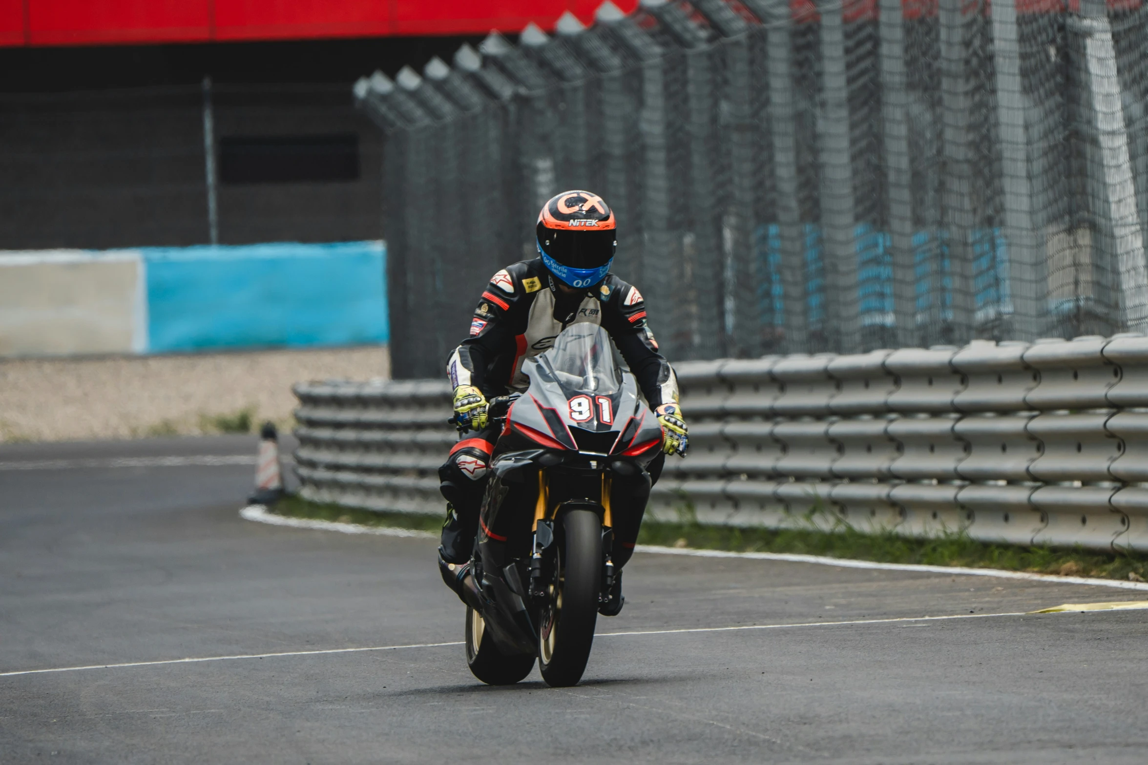 the man is riding his motorcycle on the track