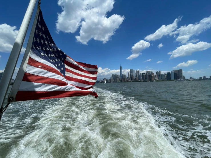 an american flag flies over the ocean waves