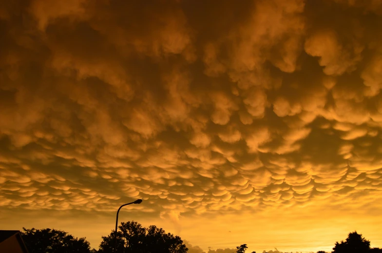 there is a long line of clouds above the cars