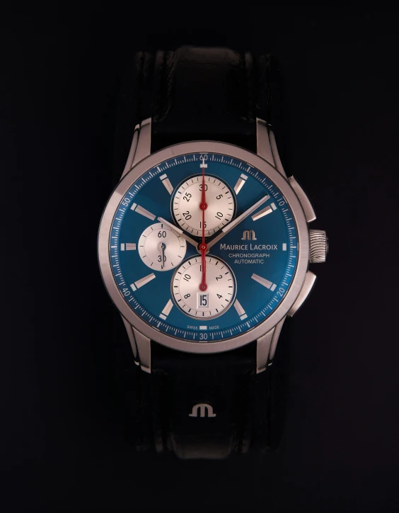 a blue and silver watch against a black background