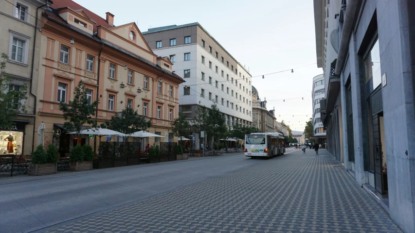 an old european street that has buildings with people walking on it