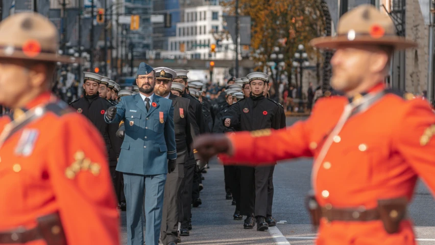 men in uniforms marching down the street