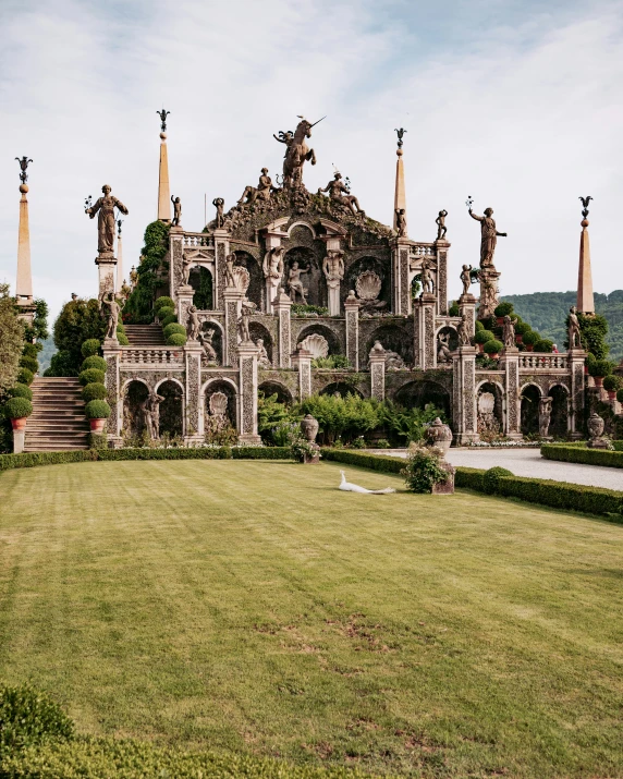 a very ornate building with statues in front