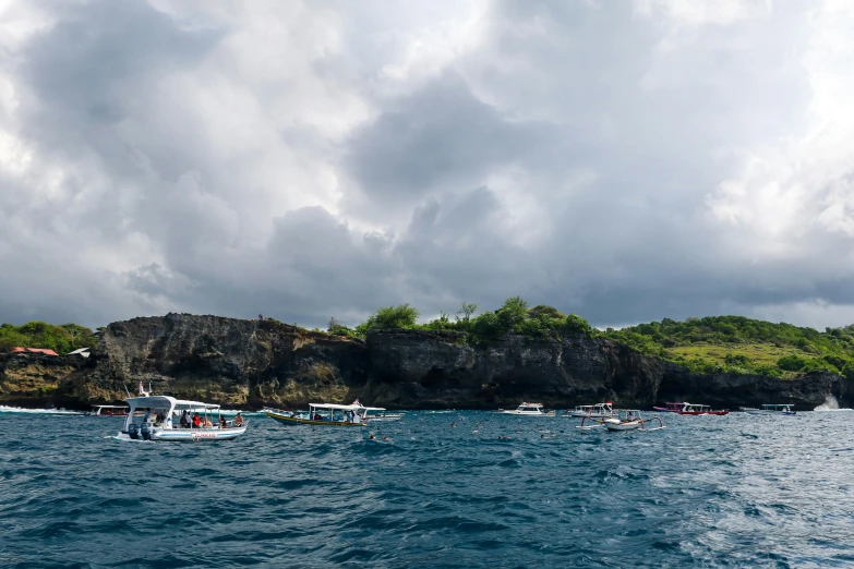 some small boats floating in a body of water