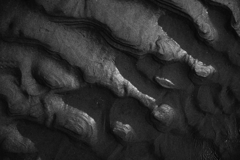 a black and white image of footprints in the sand