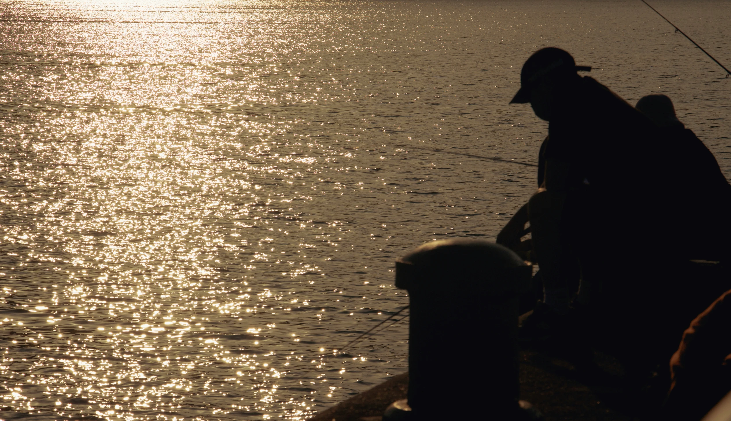 a man fishing in the water from a boat