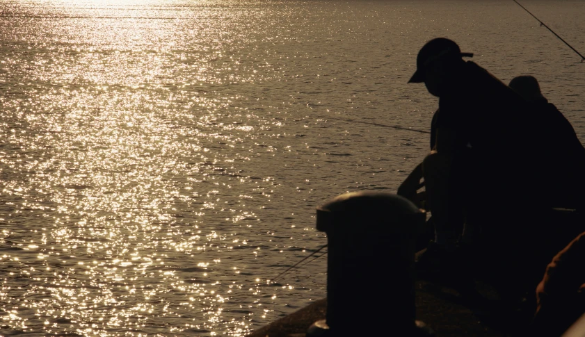 a man fishing in the water from a boat