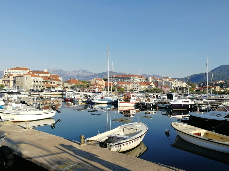 several boats are docked at the harbor in the village