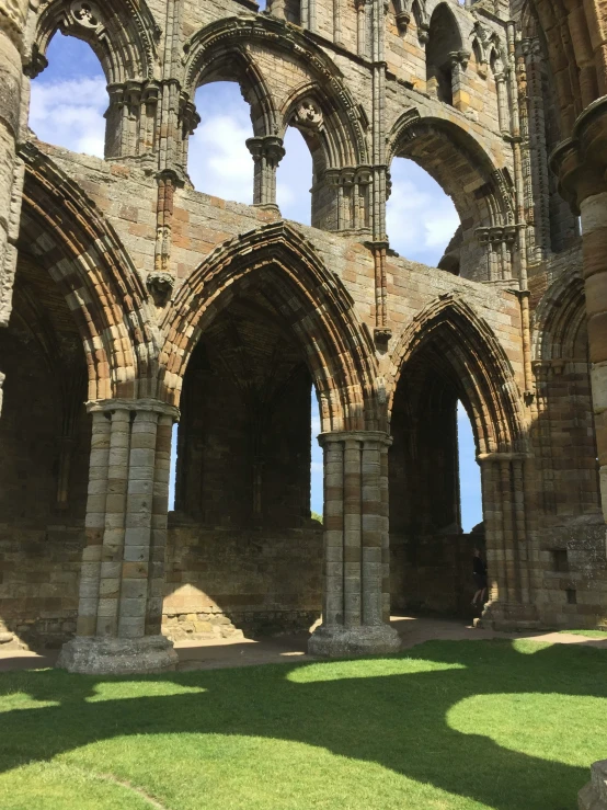 the inside of an old castle with grass