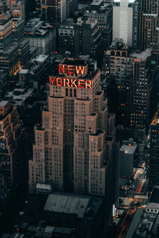 cityscape with very large and colorful neon sign on top