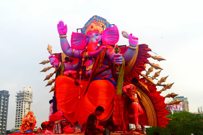 an elephant statue stands in the middle of a parade