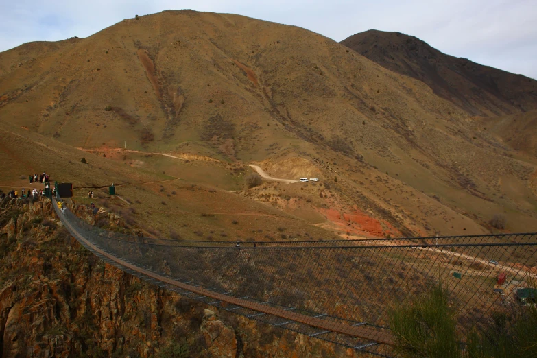 a long mountain side with a railroad going down it