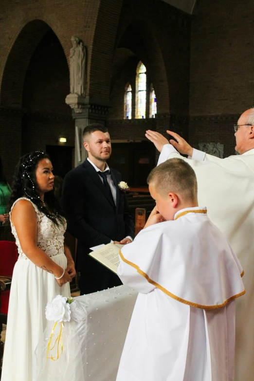 a couple receiving some married in front of an alter