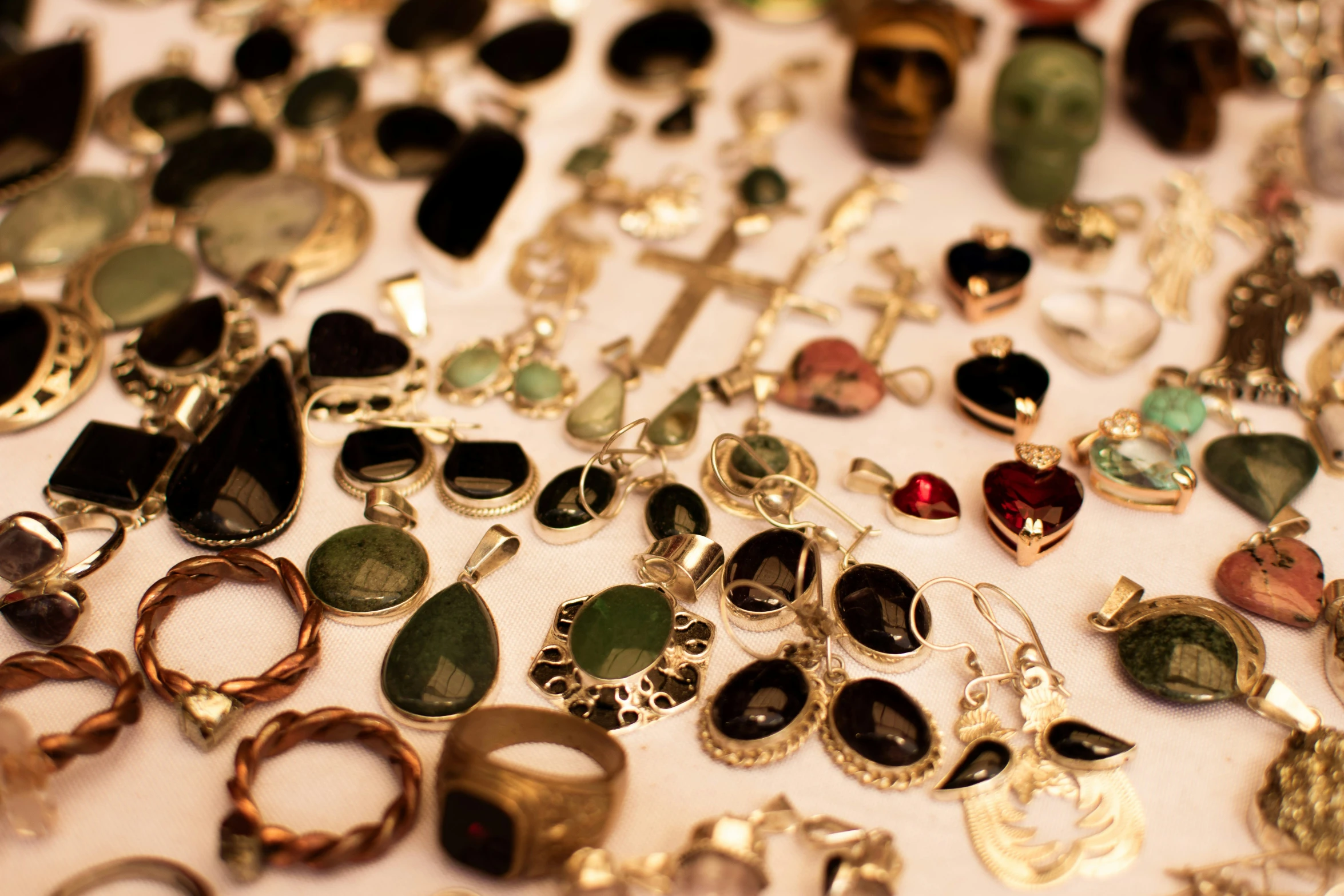 a table topped with lots of different jewelry