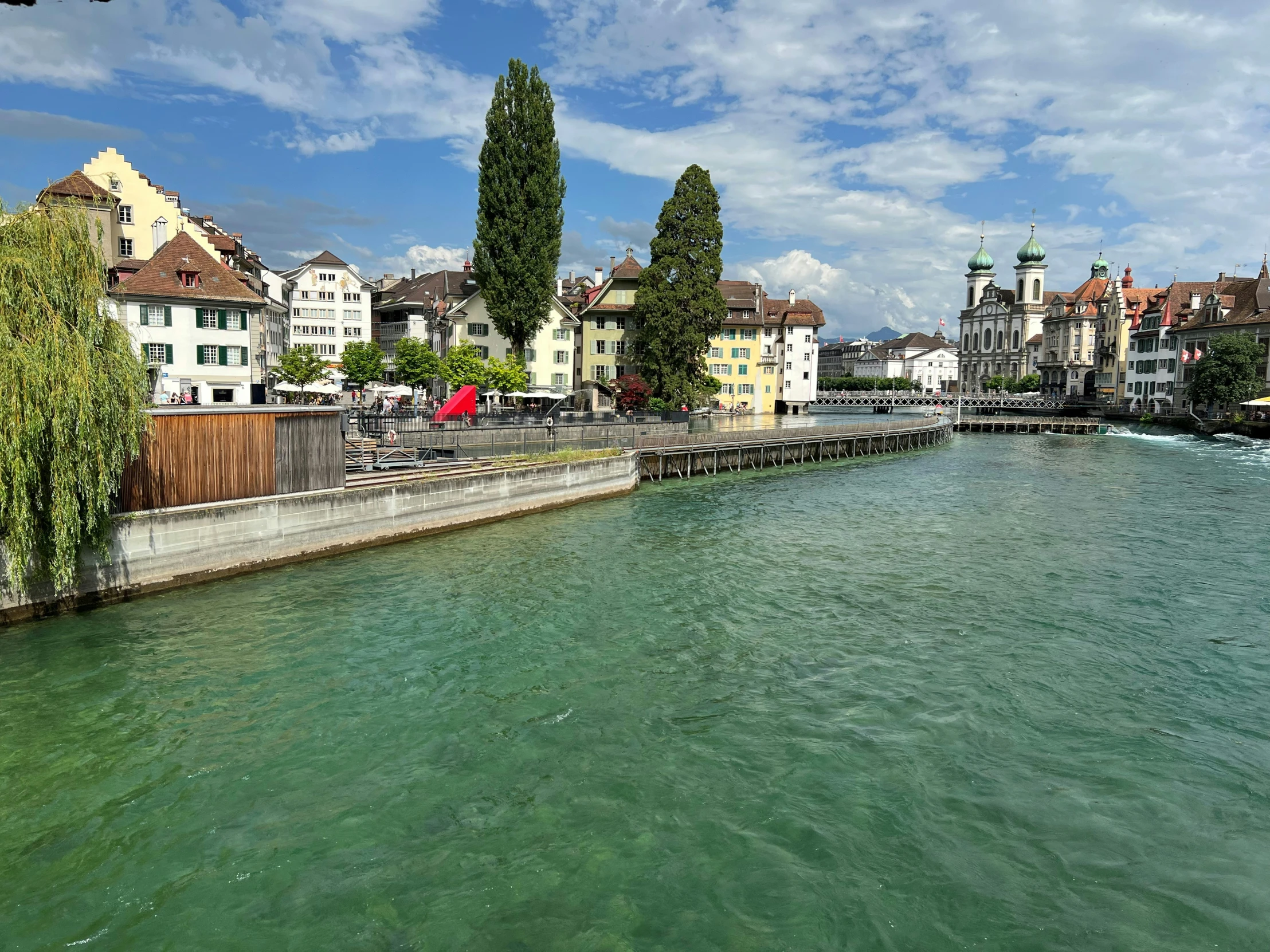 a waterway with lots of green water and trees on either side