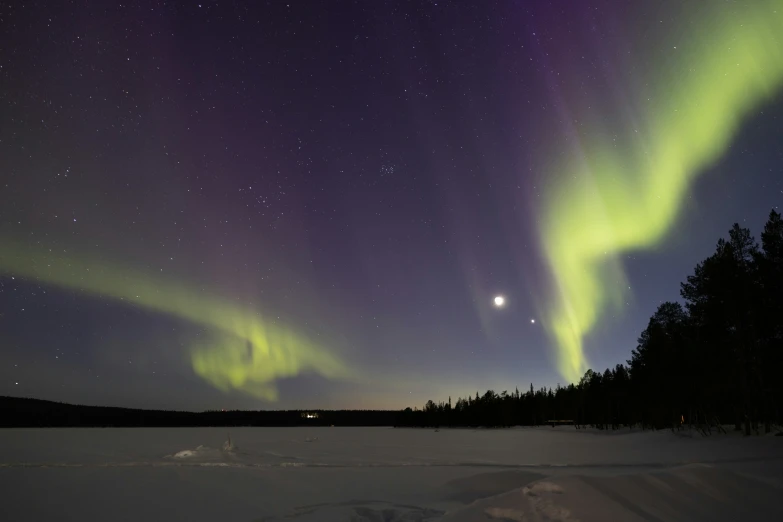 aurora bore or southern sky over an icy lake at night