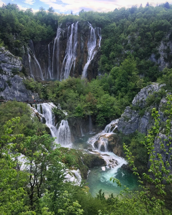 the water is flowing out of the waterfall