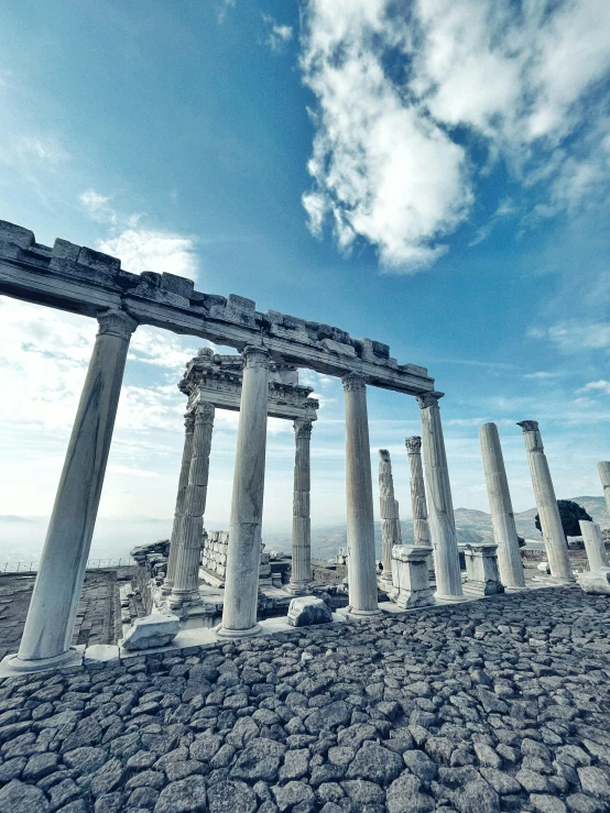 columns standing in a pattern near a rocky area