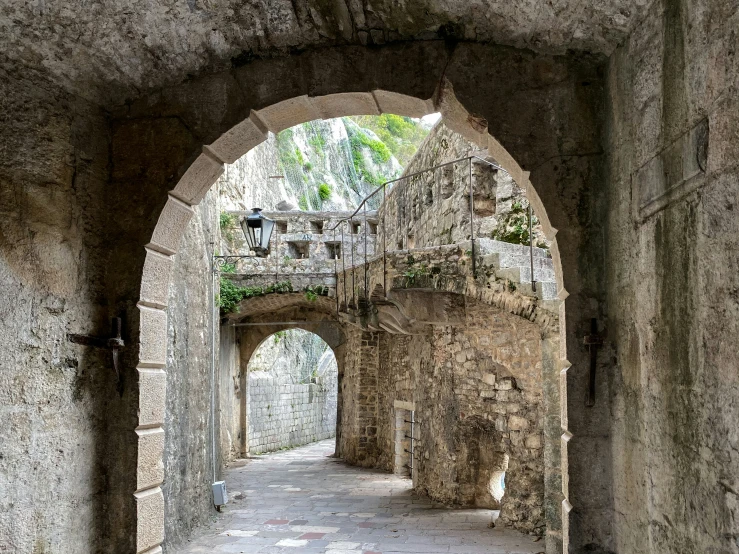 an old alley way with a clock tower in the distance