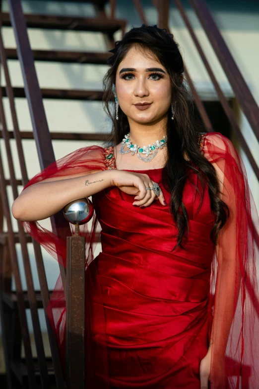 a woman posing for the camera in a red dress