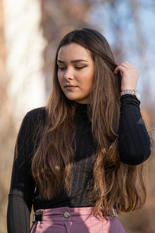 the woman is wearing an elaborate necklace and black shirt