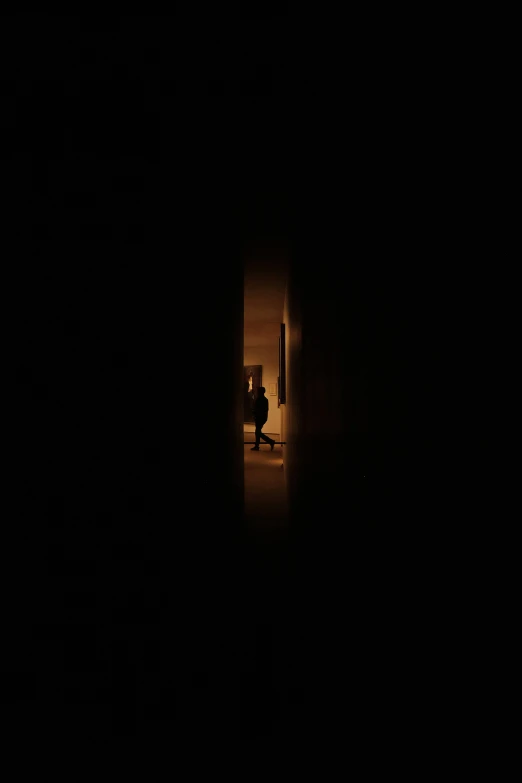 someone is standing in the dark entrance to their home