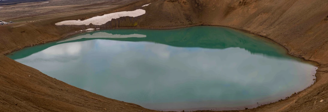 a large blue lake in an open desert