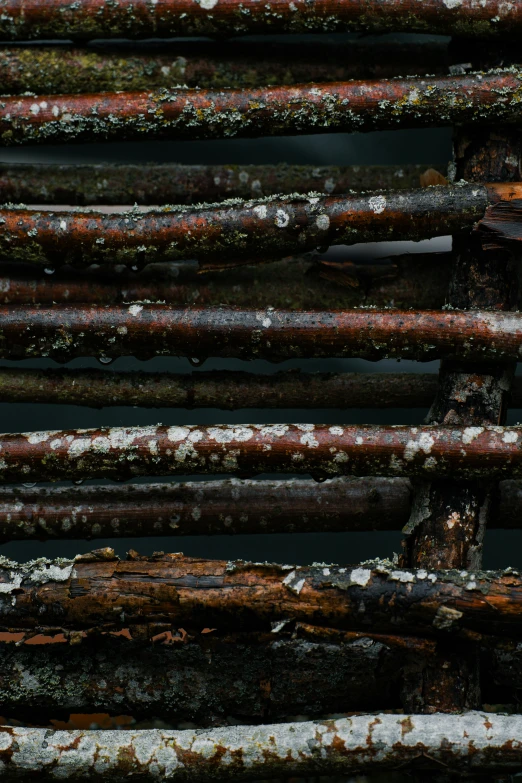 rusted metal rods are sitting in a pile