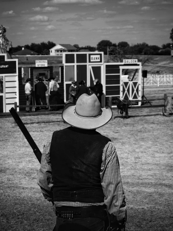 a man that is standing with a hat on