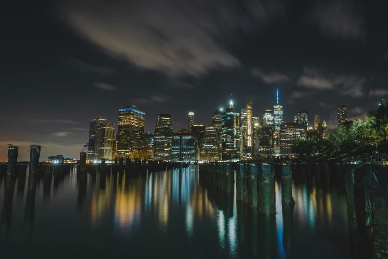 the city lights shine brightly at night over a lake