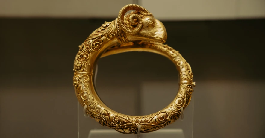 gold ring that looks like a snake is on display