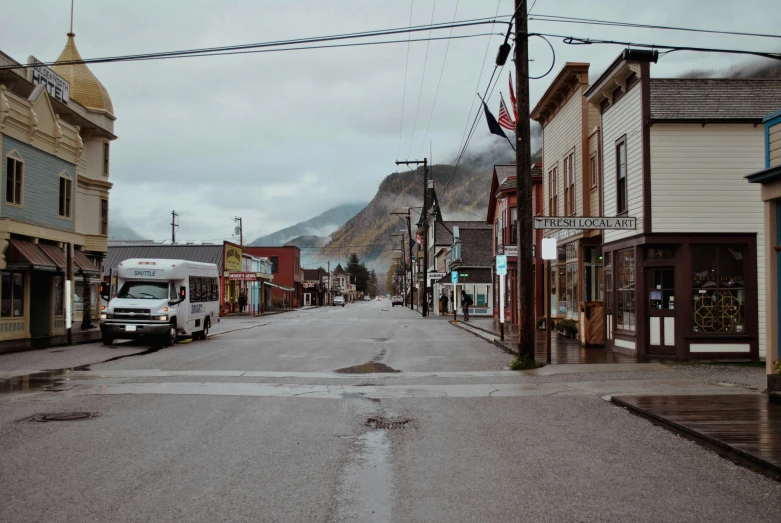 empty town street during the day with a mountain in the background
