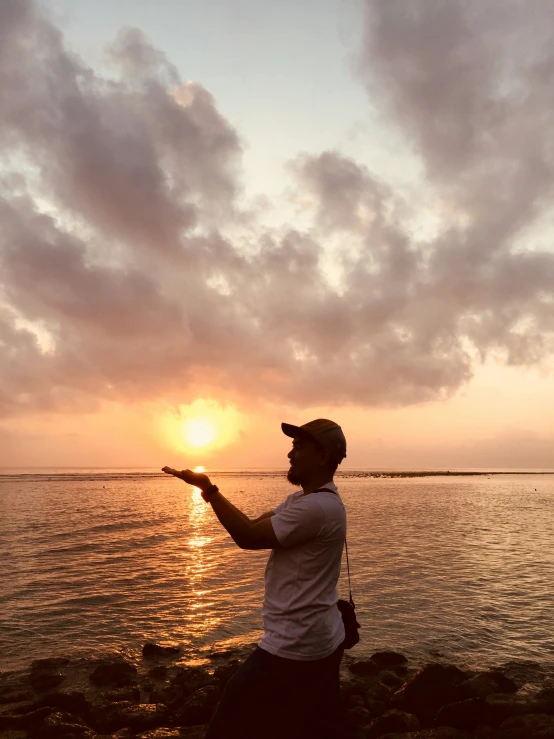 a man standing in front of the ocean