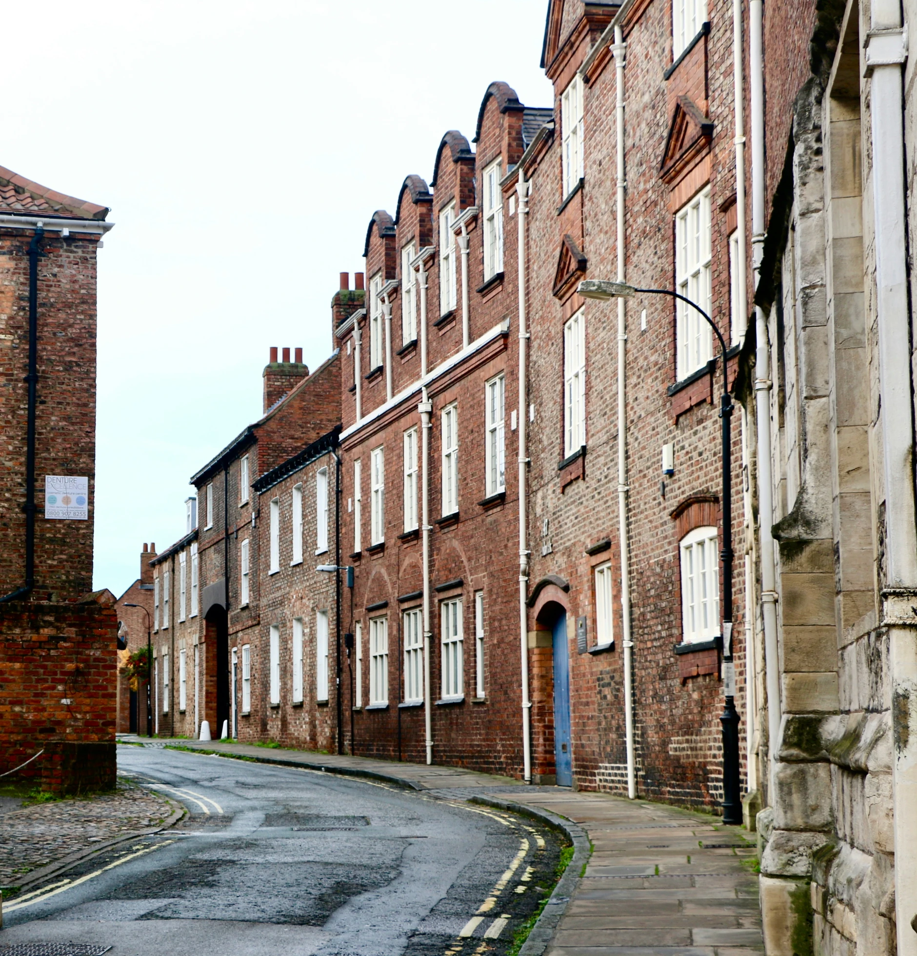 brick buildings on either side of the street and on one corner