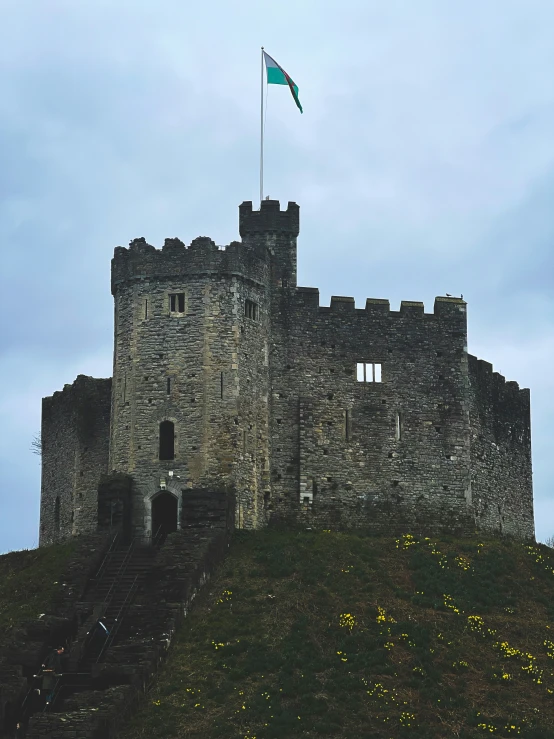 the tower on the hill has a flag flying