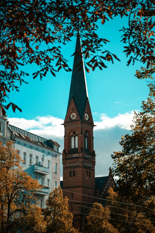 an image of a clock tower near other buildings