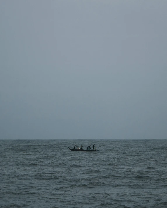 two people are in a boat near the shore