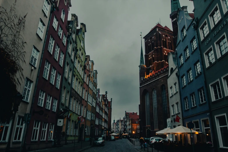 an urban street is lined with old buildings