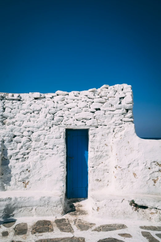 a small blue door in a stone and brick building