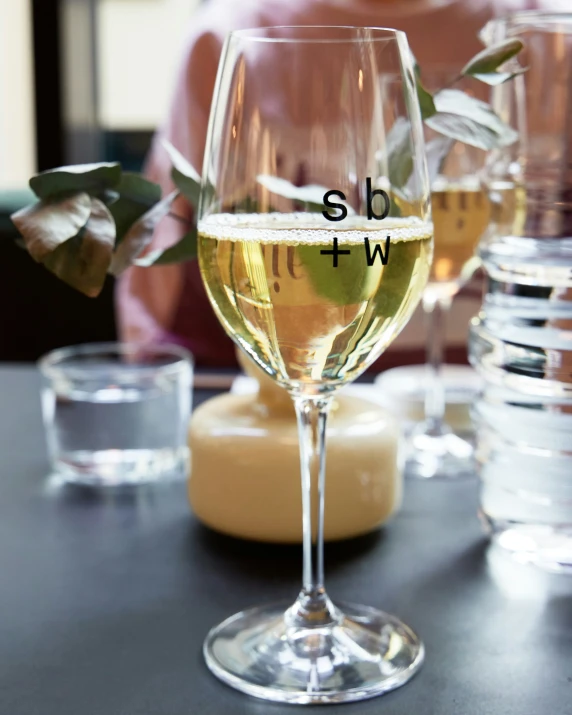 an empty wine glass with a label on it sitting on a table