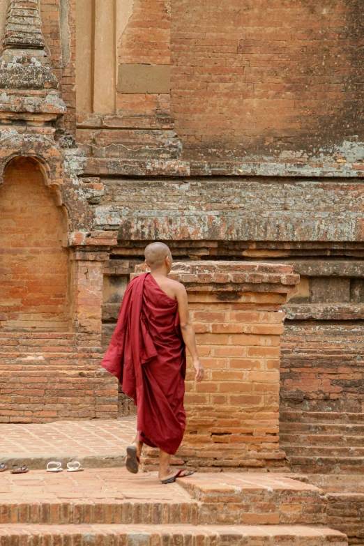 a person in a red dress walking next to some steps