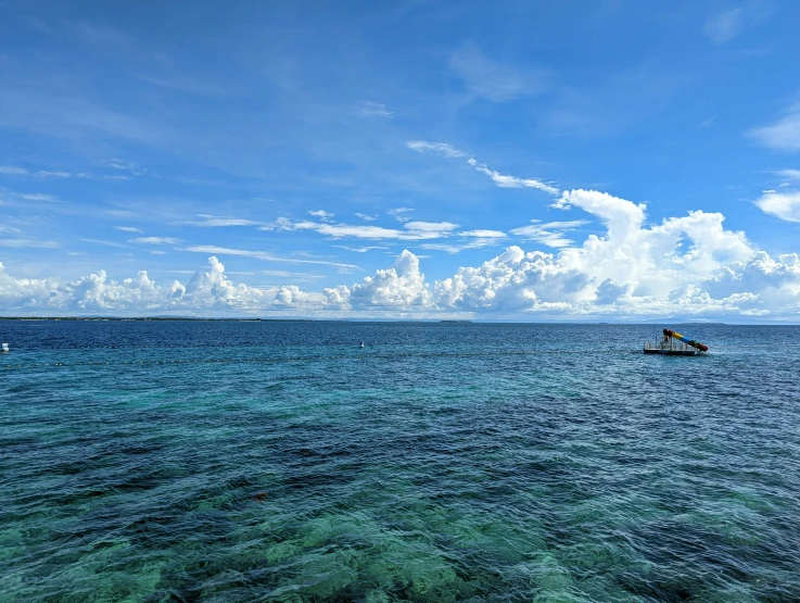 a single boat out on the open blue water