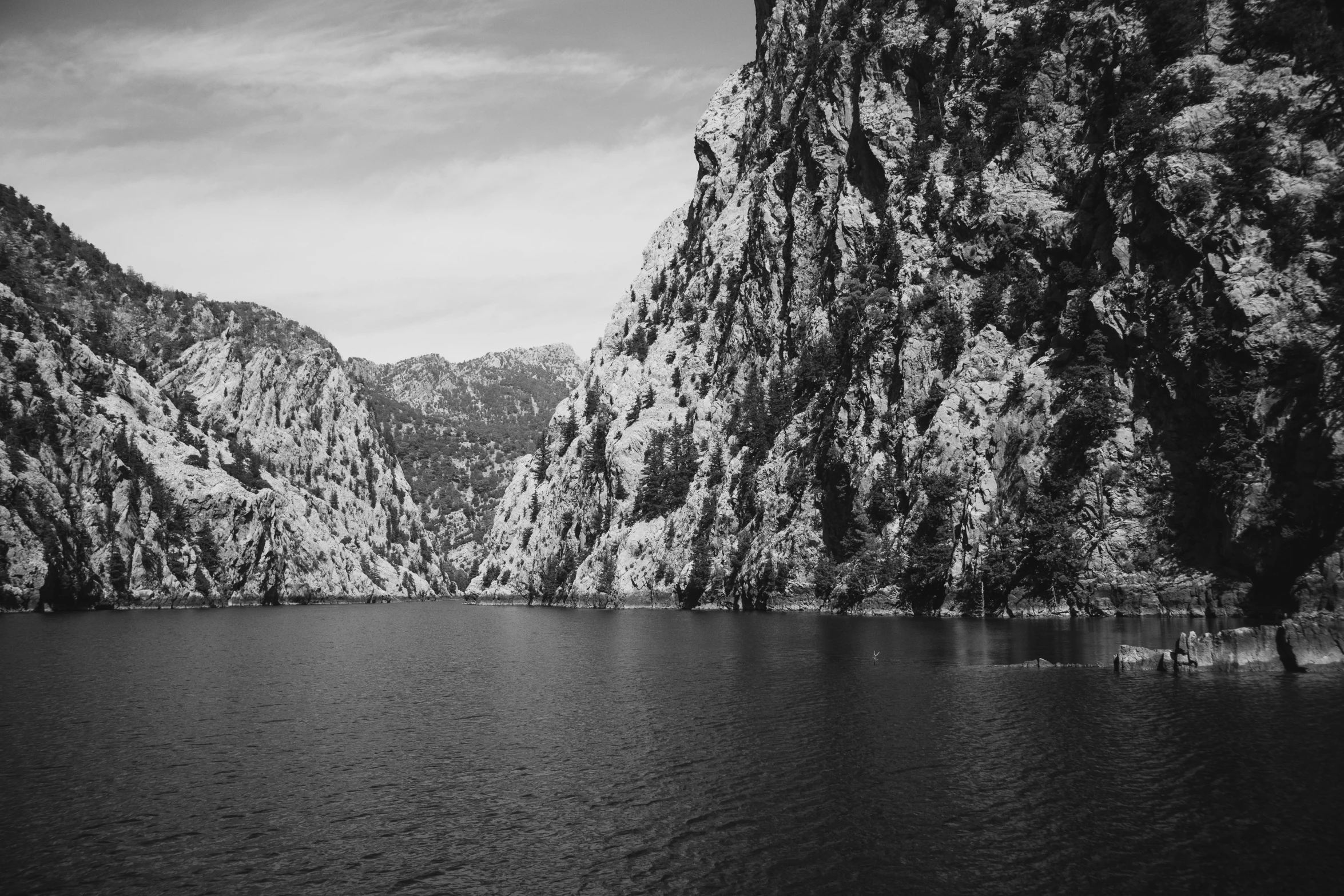 a body of water surrounded by a mountain range