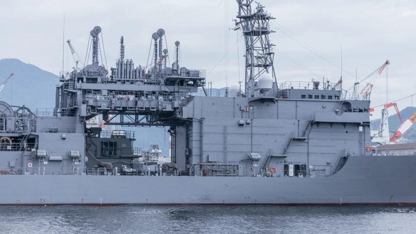 large battleship with large cranes in the water